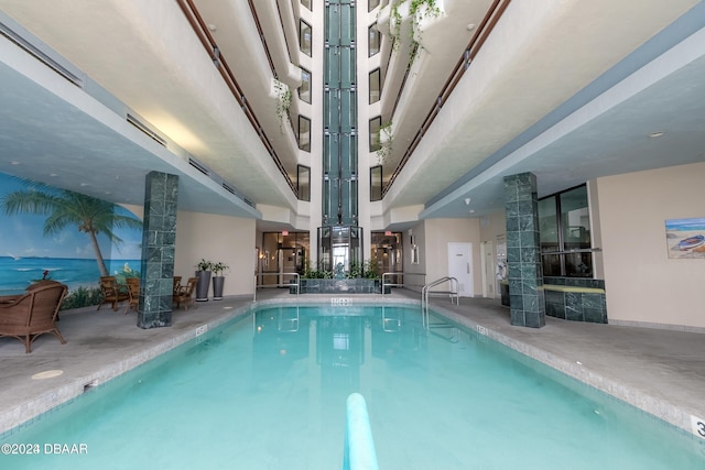 view of swimming pool with decorative columns