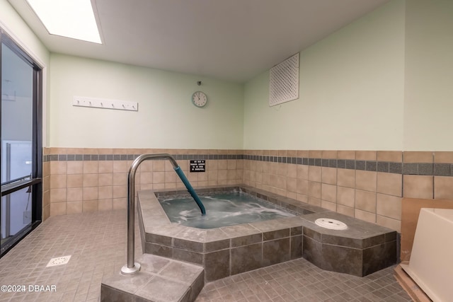 bathroom with tile walls and tile patterned flooring