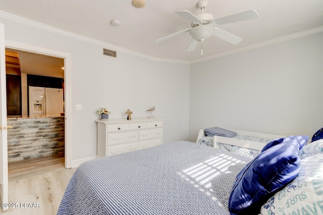 bedroom with crown molding, white fridge with ice dispenser, ceiling fan, and light hardwood / wood-style flooring