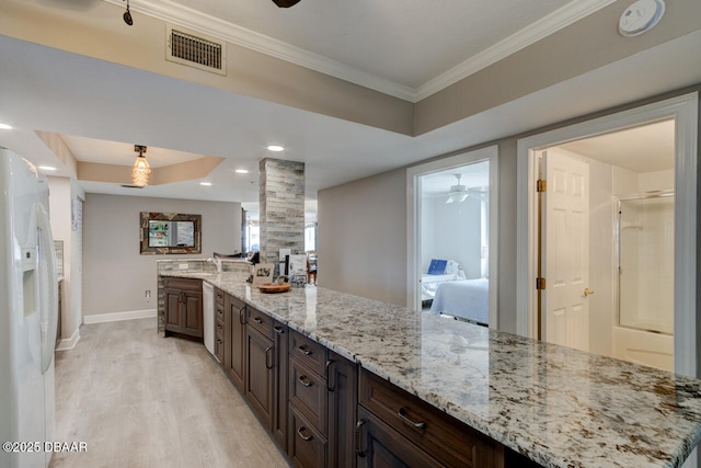 kitchen with light stone counters, crown molding, light hardwood / wood-style flooring, and white fridge with ice dispenser