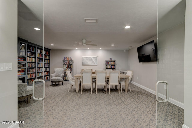 dining room featuring ceiling fan and carpet