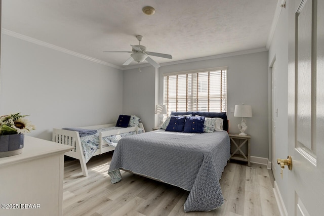 bedroom featuring crown molding, light hardwood / wood-style flooring, and ceiling fan