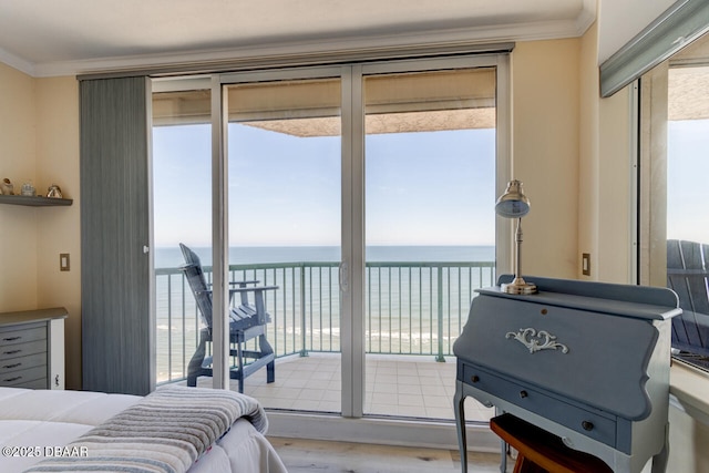 bedroom with multiple windows, ornamental molding, a water view, and access to exterior