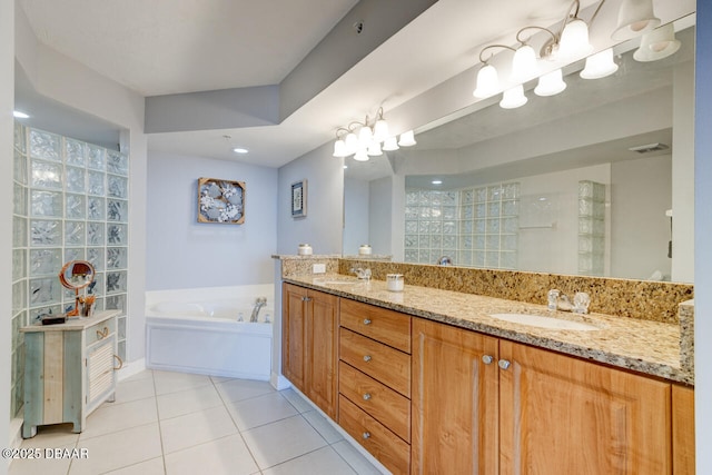 bathroom featuring vanity, a tub, and tile patterned floors