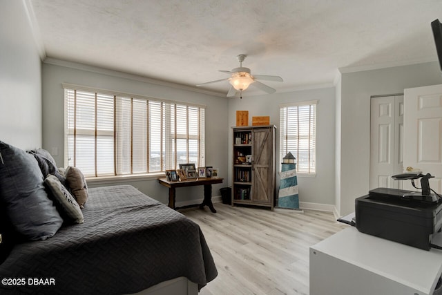 bedroom featuring ornamental molding, ceiling fan, and light wood-type flooring