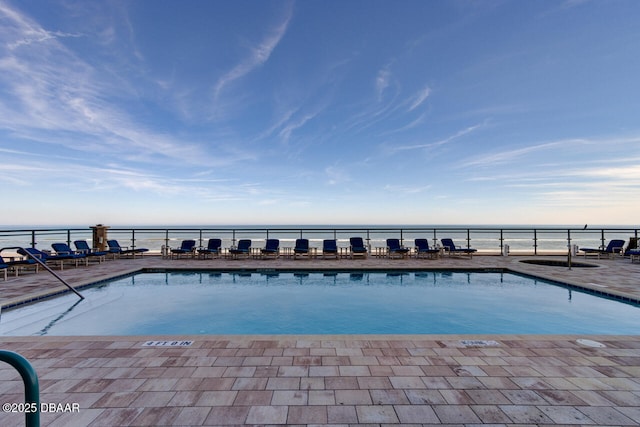 view of pool with a water view