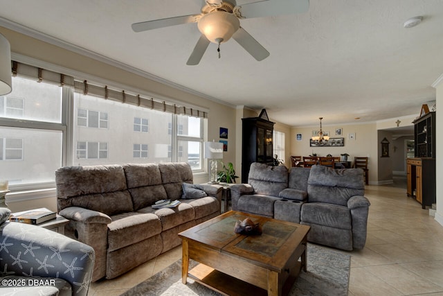 living room featuring light tile patterned floors, crown molding, and ceiling fan with notable chandelier