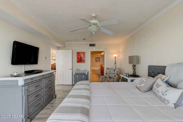 bedroom with ornamental molding, connected bathroom, ceiling fan, and light hardwood / wood-style flooring