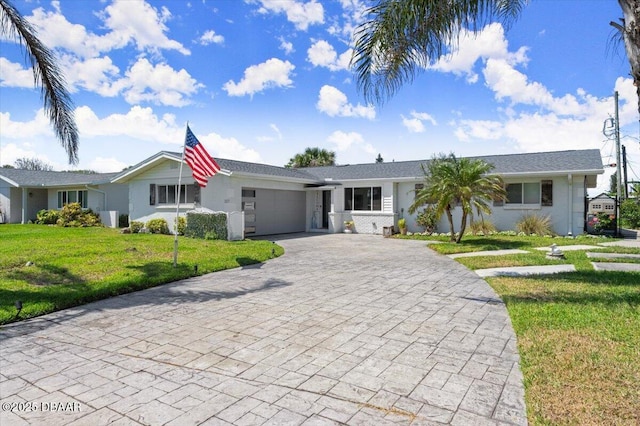 217 Royal Dunes Cir, Ormond Beach, FL 32176 - ranch-style house with an attached garage, decorative driveway, a front yard, and stucco siding