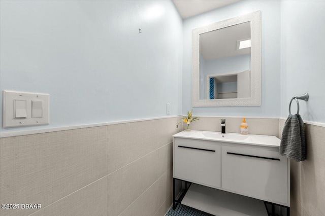 217 Royal Dunes Cir, Ormond Beach, FL 32176 - bathroom featuring vanity, a wainscoted wall, and tile walls