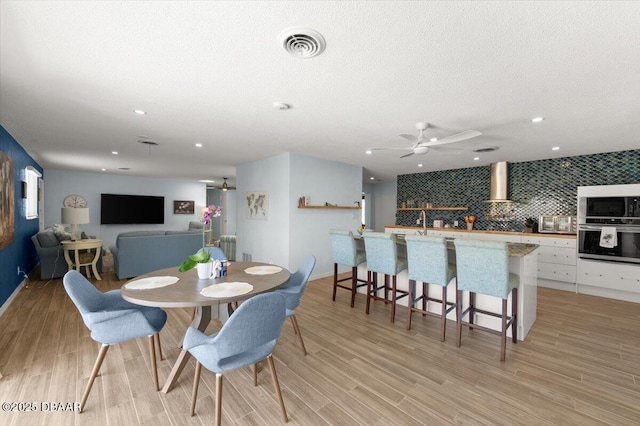217 Royal Dunes Cir, Ormond Beach, FL 32176 - dining area with ceiling fan, light wood-style flooring, recessed lighting, and a textured ceiling
