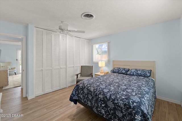 217 Royal Dunes Cir, Ormond Beach, FL 32176 - bedroom with wood finished floors, baseboards, a textured ceiling, and a ceiling fan