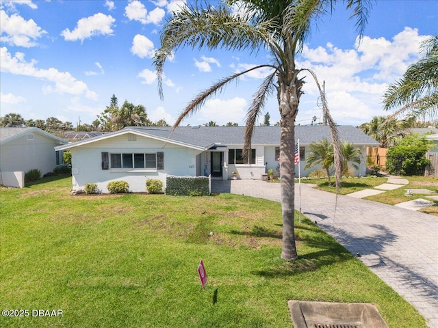 217 Royal Dunes Cir, Ormond Beach, FL 32176 - ranch-style house featuring decorative driveway, a front yard, and stucco siding