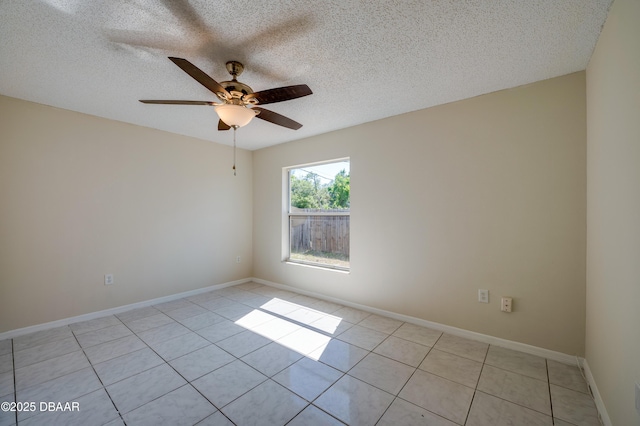 unfurnished room with light tile patterned floors, a ceiling fan, baseboards, and a textured ceiling