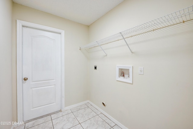 clothes washing area featuring hookup for an electric dryer, washer hookup, laundry area, and baseboards
