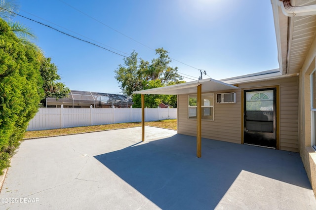 view of patio / terrace featuring fence and a wall unit AC