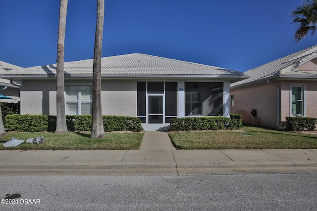 exterior space with a front yard and a sunroom