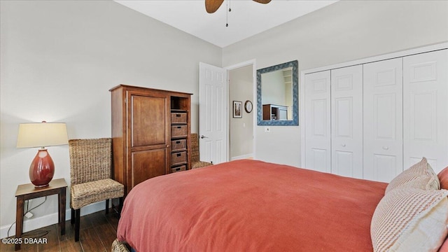 bedroom with a closet, wood finished floors, a ceiling fan, and baseboards