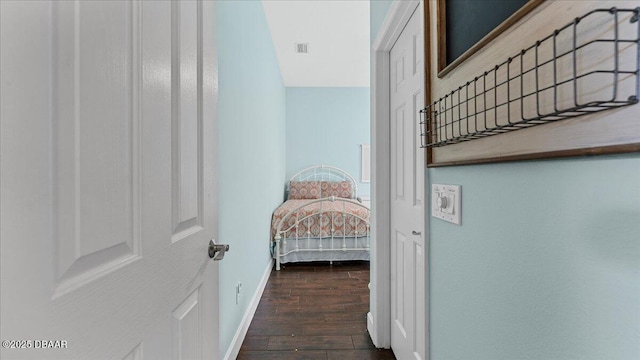 hall with wood finished floors and baseboards