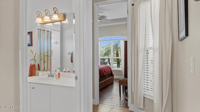 ensuite bathroom featuring ensuite bathroom, ceiling fan, and vanity