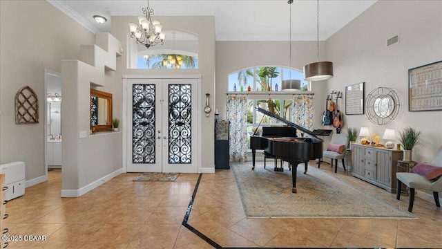 foyer entrance with baseboards, visible vents, tile patterned floors, french doors, and a notable chandelier