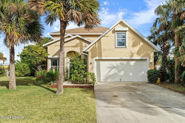 view of front of house with a garage and a front lawn