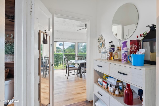 interior space featuring hardwood / wood-style flooring, ceiling fan, and vanity