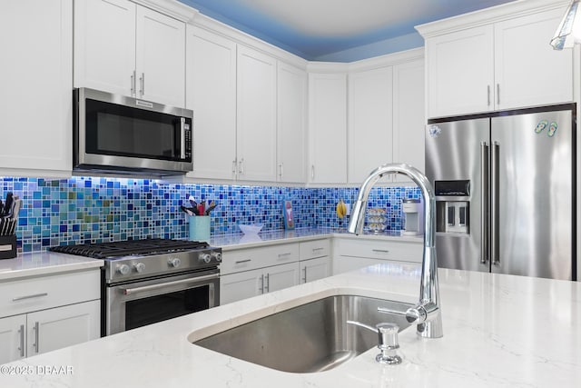 418 Good Life Way, Daytona Beach, FL 32124 - kitchen featuring stainless steel appliances, light stone counters, white cabinets, and backsplash