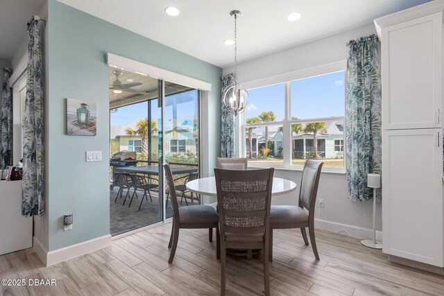 418 Good Life Way, Daytona Beach, FL 32124 - dining space with ceiling fan with notable chandelier and light hardwood / wood-style floors