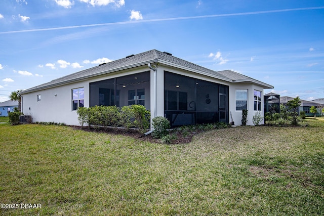 418 Good Life Way, Daytona Beach, FL 32124 - rear view of property with a sunroom, cooling unit, and a lawn