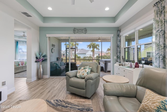 418 Good Life Way, Daytona Beach, FL 32124 - living room featuring ceiling fan, a raised ceiling, and light hardwood / wood-style floors