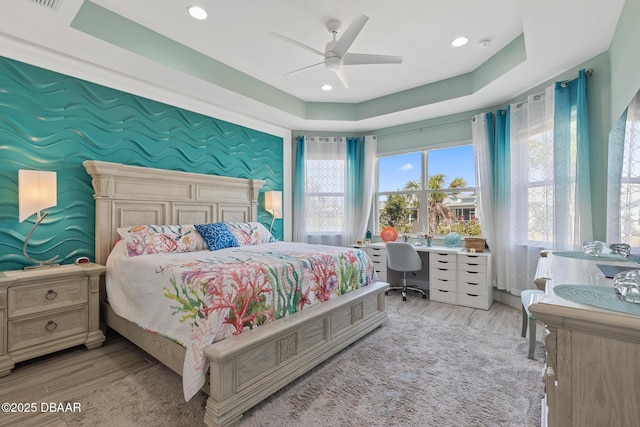 418 Good Life Way, Daytona Beach, FL 32124 - bedroom with a raised ceiling, ceiling fan, and light wood-type flooring