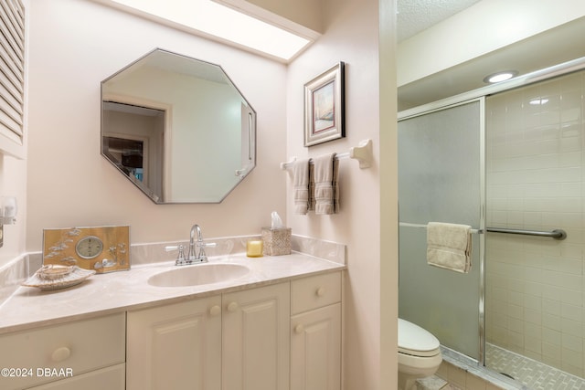 bathroom featuring tile patterned floors, walk in shower, vanity, a textured ceiling, and toilet