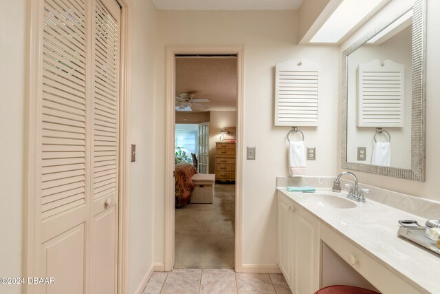 bathroom featuring vanity, ceiling fan, tile patterned flooring, and a textured ceiling