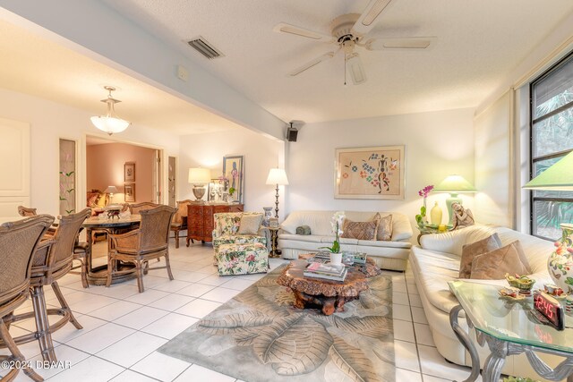 living room featuring ceiling fan and light tile patterned floors