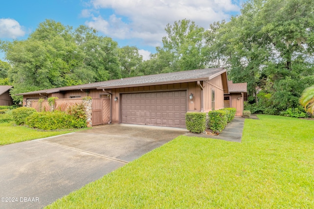 view of front of property with a garage and a front yard