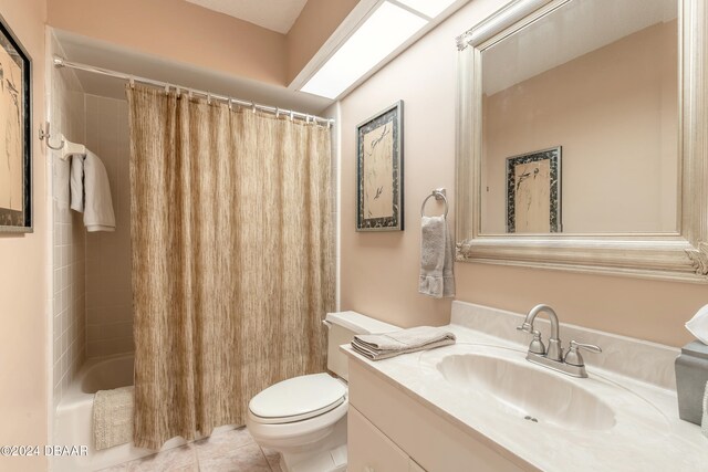 full bathroom with toilet, vanity, shower / bath combo with shower curtain, and tile patterned floors