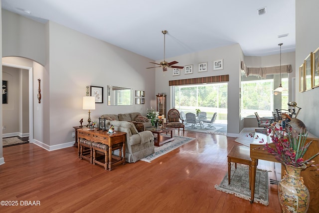 850 Westlake Dr, Ormond Beach, FL 32174 - living area with a ceiling fan, visible vents, arched walkways, wood finished floors, and baseboards
