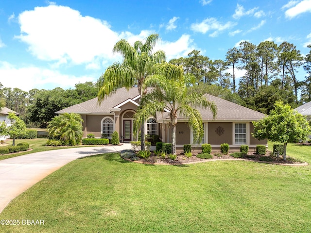 850 Westlake Dr, Ormond Beach, FL 32174 - view of front of property featuring driveway, a front lawn, roof with shingles, and stucco siding