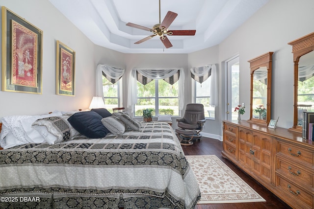 850 Westlake Dr, Ormond Beach, FL 32174 - bedroom featuring a raised ceiling, a ceiling fan, and dark wood finished floors