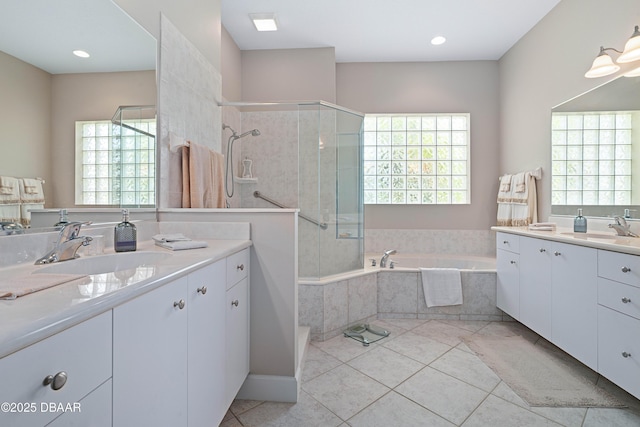 850 Westlake Dr, Ormond Beach, FL 32174 - bathroom with a garden tub, a sink, a stall shower, and tile patterned flooring