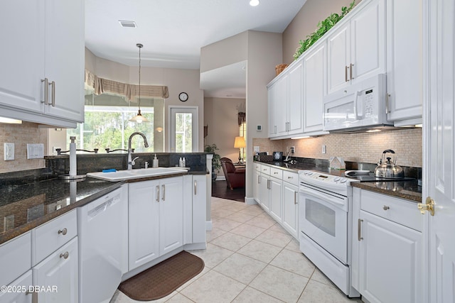 850 Westlake Dr, Ormond Beach, FL 32174 - kitchen featuring white appliances, white cabinetry, and a sink