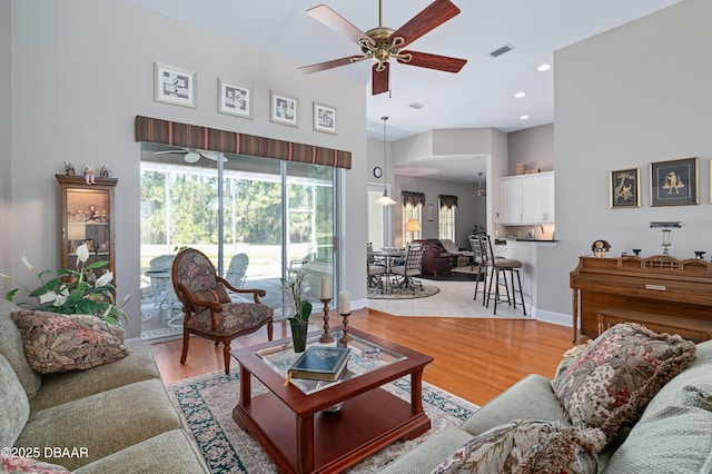 850 Westlake Dr, Ormond Beach, FL 32174 - living room featuring visible vents, a ceiling fan, light wood-style flooring, and a towering ceiling