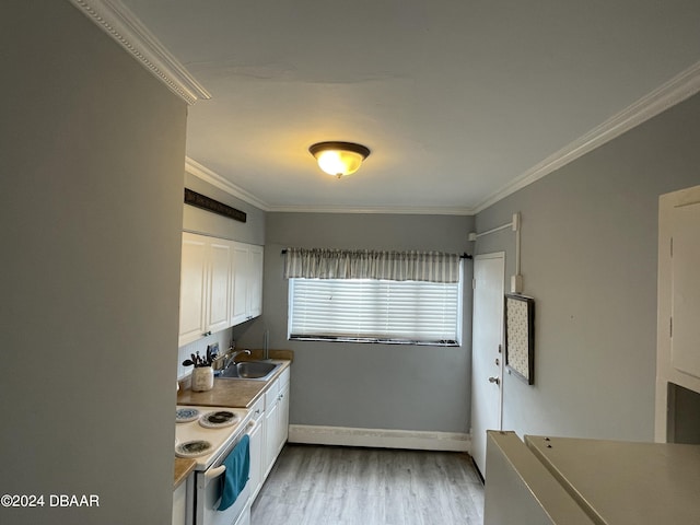 500 S Beach St Unit F-1, Daytona Beach, FL 32114 - kitchen with white range with electric cooktop, white cabinetry, crown molding, wood finished floors, and a sink