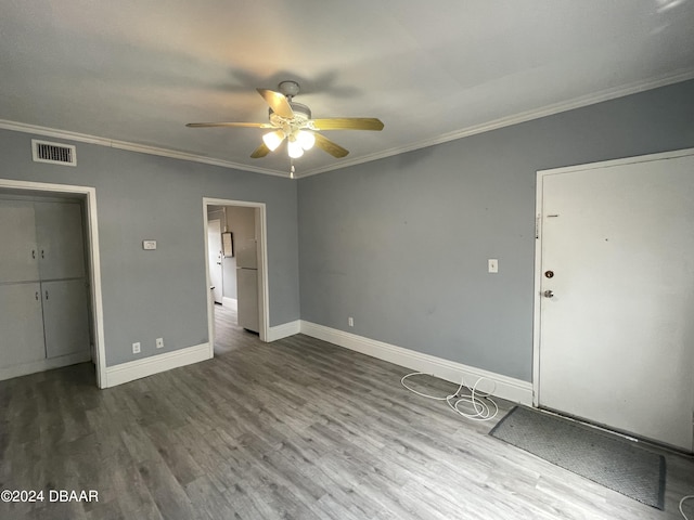 500 S Beach St Unit F-1, Daytona Beach, FL 32114 - unfurnished bedroom featuring crown molding, wood finished floors, baseboards, and ceiling fan