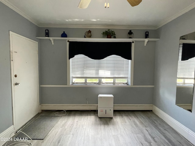 empty room with ornamental molding, hardwood / wood-style floors, and ceiling fan