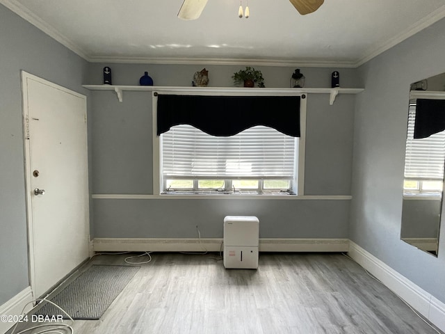 500 S Beach St Unit F-1, Daytona Beach, FL 32114 - spare room featuring healthy amount of natural light, wood finished floors, ceiling fan, baseboards, and crown molding