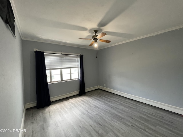 500 S Beach St Unit F-1, Daytona Beach, FL 32114 - empty room featuring crown molding, a ceiling fan, wood finished floors, a baseboard radiator, and baseboards
