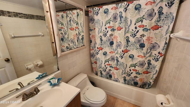 full bathroom featuring tile patterned floors, toilet, tile walls, vanity, and shower / bath combination with curtain