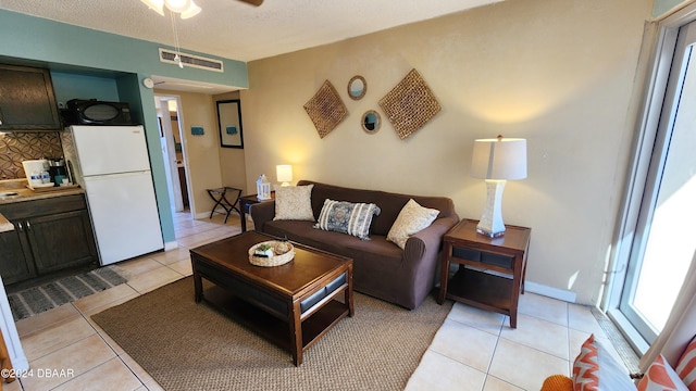 219 S Atlantic Ave Unit 135, Daytona Beach, FL 32118 - living area with light tile patterned floors and a ceiling fan